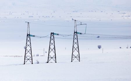 electric pole in the snow in the winterの写真素材