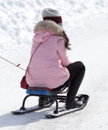 child riding a roller coaster in the winter