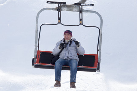 Shymkent, KAZAKHSTAN - February 5, 2017: A man with a camera on a winter resort Tausamalyのeditorial素材
