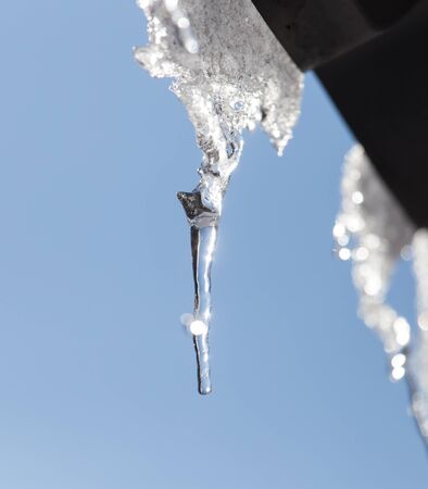 Icicles from the roof of the houseの写真素材