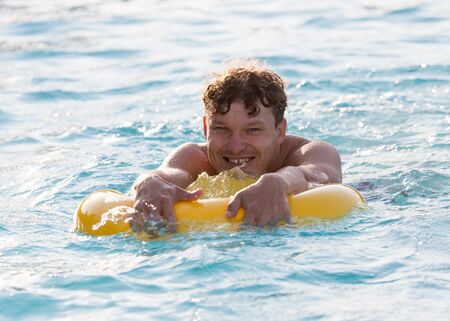 The man is swimming in the poolの写真素材