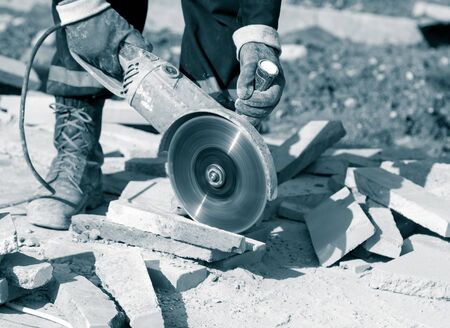 Worker cuts paving slabsの写真素材