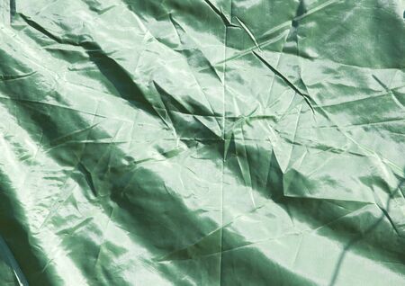 Green crumpled fabric as backgroundの写真素材