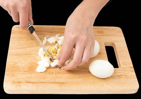 cook eggs on cutting board on a black backgroundの写真素材
