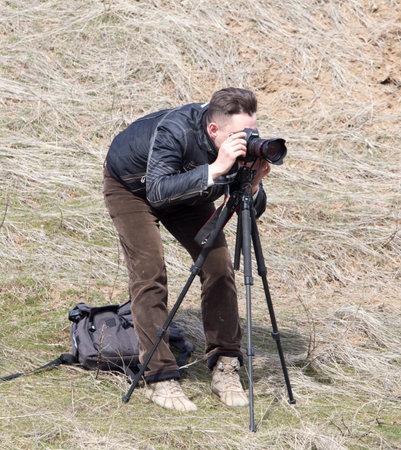 Shymkent, KAZAKHSTAN - February 26, 2017: Photographer on Russian holiday Maslenitsa