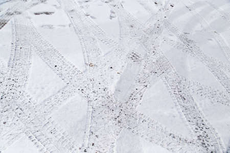 traces of cars on the road in winter .の写真素材