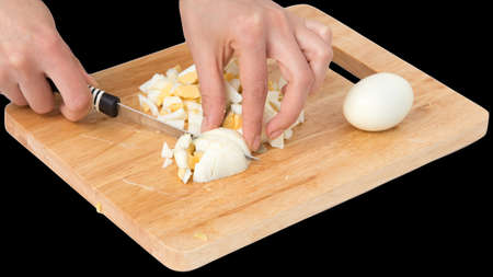 cook eggs on cutting board on a black background .の写真素材