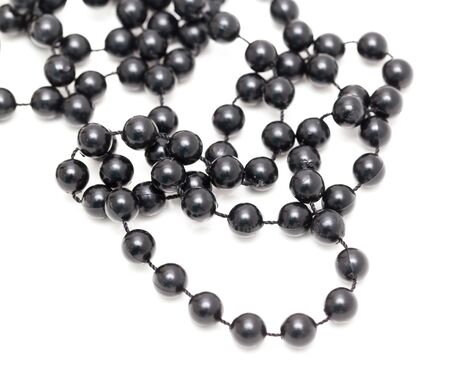 Black beads on a white backgroundの写真素材
