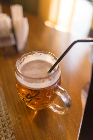 A beer mug in a restaurantの写真素材