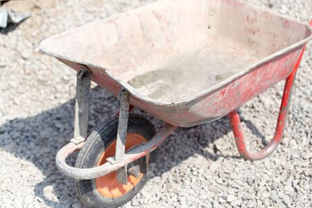 A cement wheelbarrow at the construction siteの写真素材