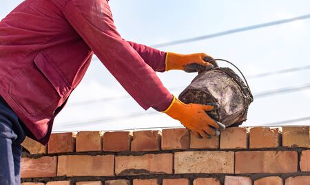 Worker builds a brick wall in the houseの写真素材