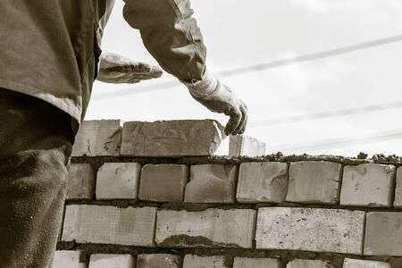 Worker builds a brick wall in the houseの写真素材