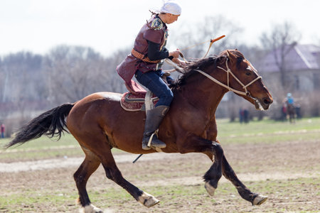 Shymkent, KAZAKHSTAN - 22 March 2017: Celebration of the Kazakh holiday NARIYZ. Archery from a horseのeditorial素材