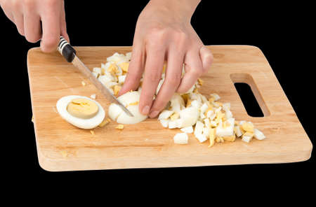 cook eggs on cutting board on a black backgroundの写真素材