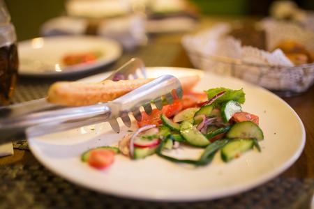 Dish with tomatoes and cucumbers in a restaurant .の写真素材