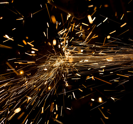 Sparks from metal on construction site as background .