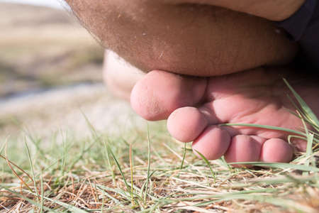 bare foot man on grassの写真素材