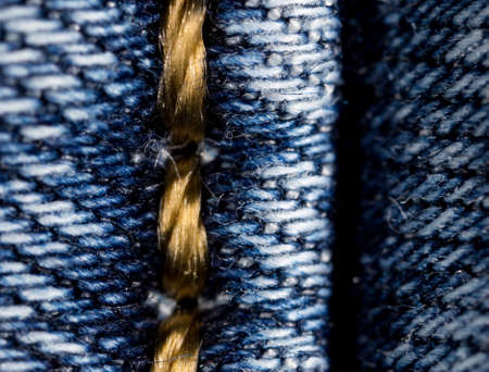 thread on jeans as a background. macroの写真素材