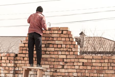 Worker builds a brick wall in the house .の写真素材