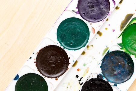 Old used paints on a wooden background .の写真素材