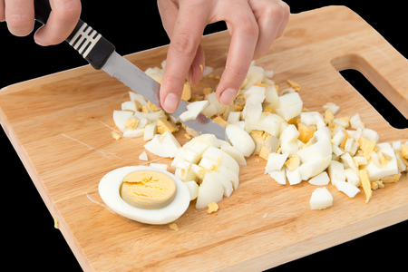 cook eggs on cutting board on a black background .の写真素材