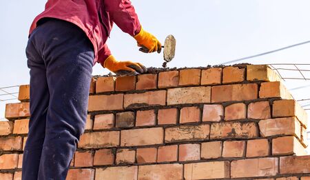 Worker builds a brick wall in the house .の写真素材
