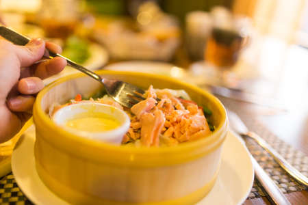 Fish with vegetables in a couple in a restaurant .の写真素材