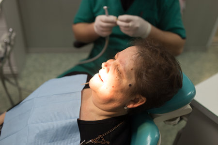 The dentist works with the client in the clinic .のeditorial素材