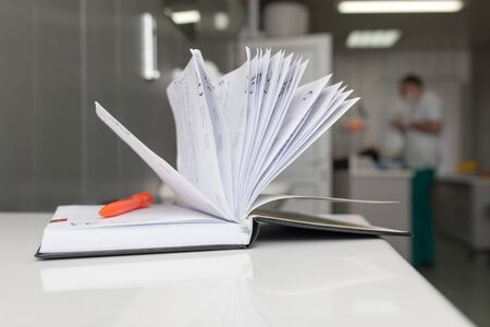 A notebook with a pen on the table in the clinic .の写真素材