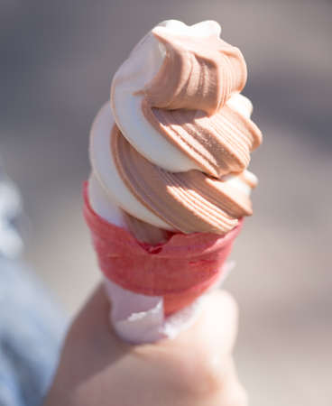 Ice cream in a waffle cup in a hand .の写真素材