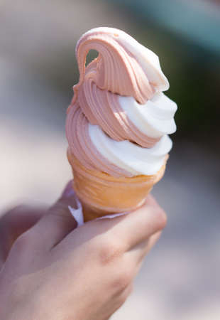 Ice cream in a waffle cup in a hand .の写真素材