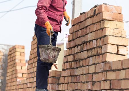 Worker builds a brick wall in the house .の写真素材