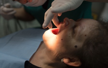 The dentist works with the client in the clinic .の写真素材