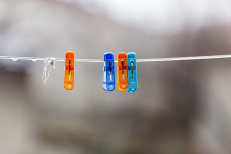 A Colorful clothespins on the clothesline outdoors .の写真素材