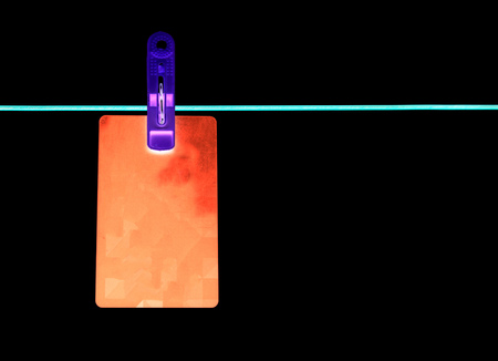 Card on a rope on a black background .
