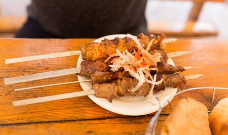 Fried shish kebab on sticks in a cafe .の写真素材