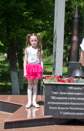 SHYMKENT, KAZAKHSTAN - MAY 9, 2017: A girl at the Victory Day of the Red Army and Soviet people in the Great Patriotic War of 1941-1945.のeditorial素材