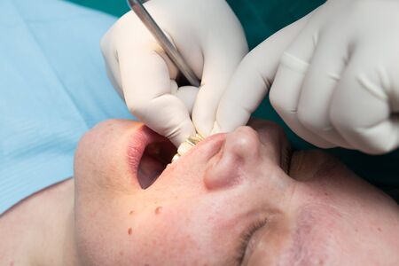 The dentist works with the client in the clinic .