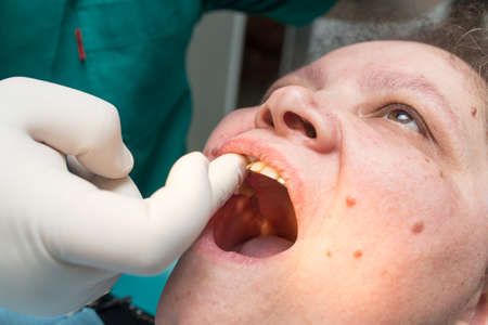 The dentist works with the client in the clinic .