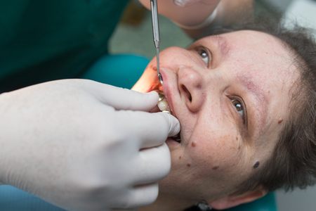 The dentist works with the client in the clinic .