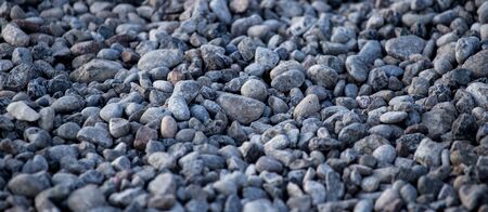 Crushed stone on the road as a background .