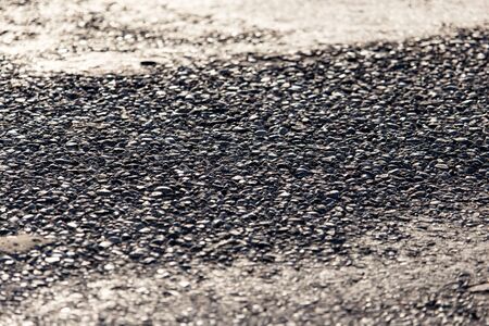 Old black asphalt on the road as background