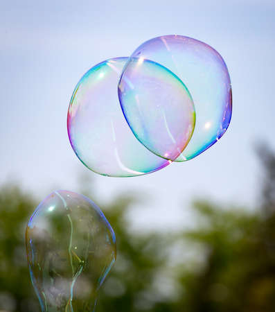 Beautiful soap bubbles fly in the nature .