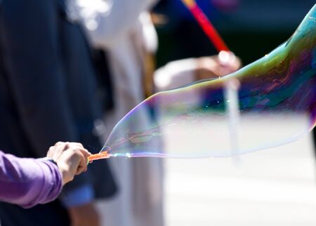 Beautiful soap bubbles fly in the city .