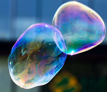 Beautiful soap bubbles fly in the city .