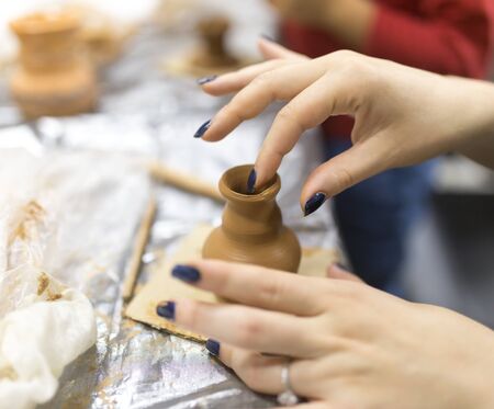 The master makes by hands the product of dishes from clayの写真素材