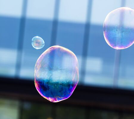 Beautiful soap bubbles fly in the city .