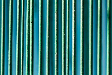 Metallic fence painted with green paint as a background .の写真素材