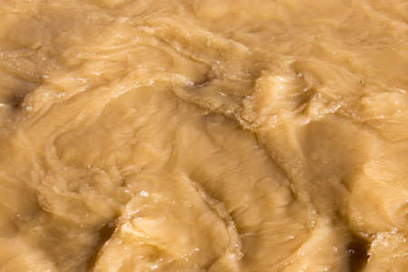 Dirty water in a stormy river as a background .の写真素材