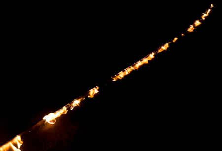 Strip of fire on a black background .